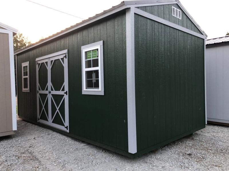 green, large shed with barn doors and white trim 